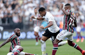 Wesley passando por entre dois jogadores do Fluminense, que tentam desarm-lo