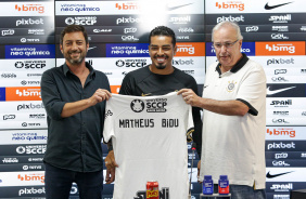 Matheus Bidu sorrindo com a camisa ao lado de Duilio e Roberto de Andrade