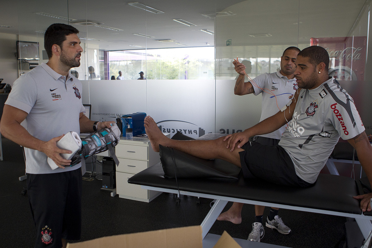 O atacante Adriano, com os fisioterapeutas Bruno Mazziotti(e) e Caio Mello, continua sua fisioterapia durante o treino do Corinthians realizado esta tarde no CT Joaquim Grava, no Parque Ecológico do Tiete. O time se prepara para o jogo contra o Santos, domingo a tarde, dia 15/05, na Vila Belmiro, em Santos, decisão do Campeonato Paulista 2011